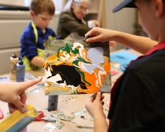 a child shows off their artwork