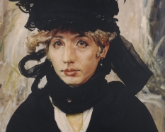 A person, whose gender is unidentified, is wearing a large black hat and puffy black dress. The person is sitting and staring at the viewer.