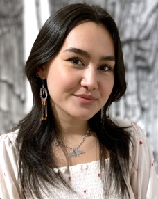 A headshot of a young Native American woman with dark brown hair and brown eyes.