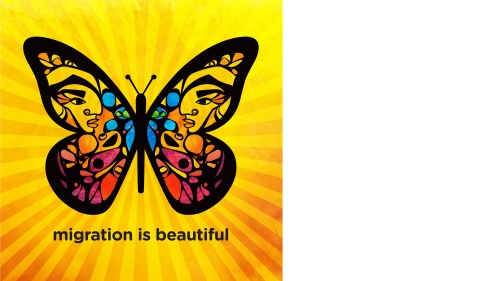 A brightly colored poster, made by a hispanic artist, of a butterfly. On the butterfly's wings is a drawing of a profile on each side. Underneath the butterfly the poster reads,"Migration is Beautiful."