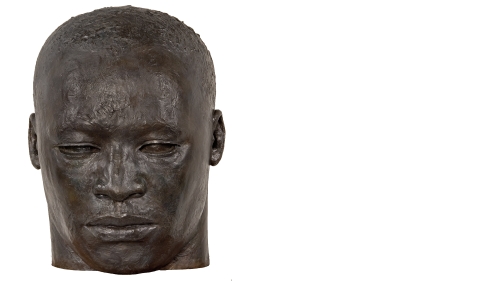 A large bronze sculpture of MLK Jr's head and face.
