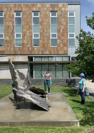 Conservators Helene Gillette-Woodward and Nora Frankel, from the Williamstown Art Conservation Center, cleaning Kiki Smith's "Refuge" (2014) in June 2019. Photo by Alison Palizzolo.