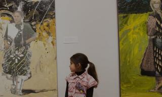 Child appreciating Native American art