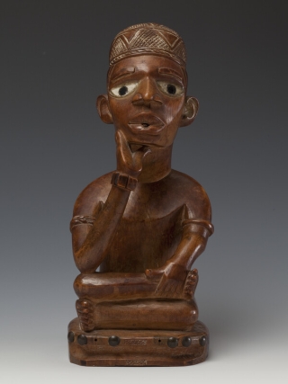Memorial figure of a clan leader (mfumu kanda) made from wood, kaolin clay, glass, and brass tacks.