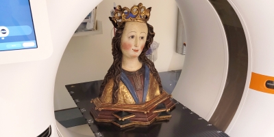 A medieval reliquary bust sits on a CT scanner at DHMC. Photo by Ashley Offill.