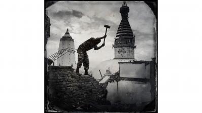 Kevin Bubriski, Members of the Nepalese Army assisted in the demolition of unsafe shops and houses on top of Swayambhunath Hill. The ancient stupa, or shrine, in the background, suffered no major damage, 2015, archival pigment digital print. 