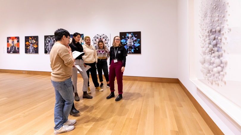 Museum Club member Sophia Swanson '23 speaks with students about Lin Tianmiao's Focus No. 30 (2003) during the winter 2020 Hood After 5 student party. Photo by Lars Blackmore.