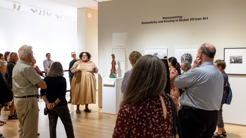 Alexandra Thomas, curatorial research associate at the Hood Museum of Art leads a tour of Homecoming: Domesticity and Kinship in Global African Art. Photo by Rob Strong.