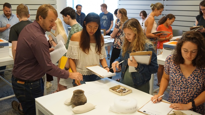 Students in Nathaniel Kitchel's Introduction to Archaeology compare sherds and complete vessels. Photo by Randall Kuhlman.