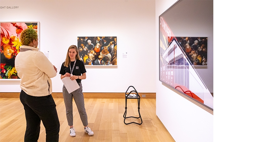 Photograph of Abby Smith '23 and student in Albright Gallery