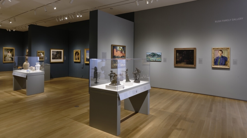 A museum gallery installation that features American art objects and paintings.