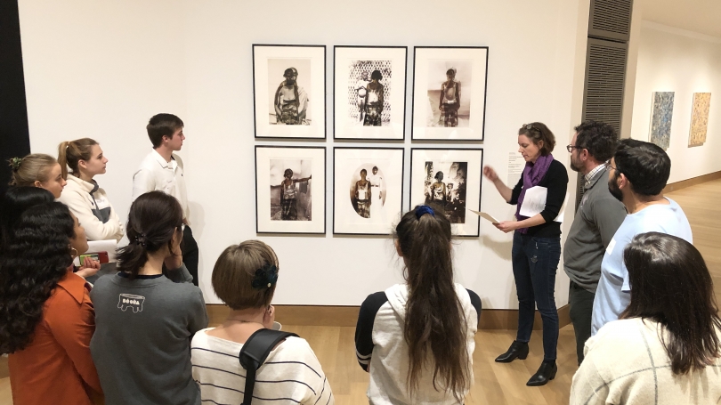 Students attending the West House Alternative Spring Break trip discuss a series of photographs by Nomusa Mahkubu.