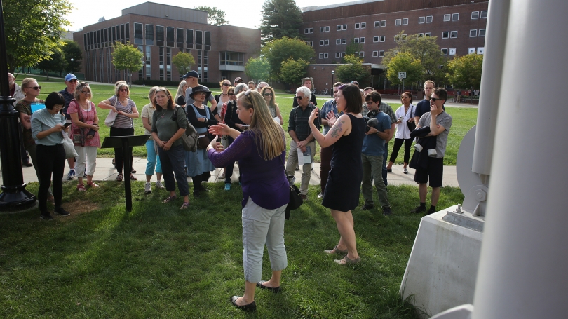 Amelia Kahl (right) gives an introduction to Bill Fontana’s MicroSoundings during the Resonant Spaces symposium walking tour. Denise Khaler (left) interprets into ASL.