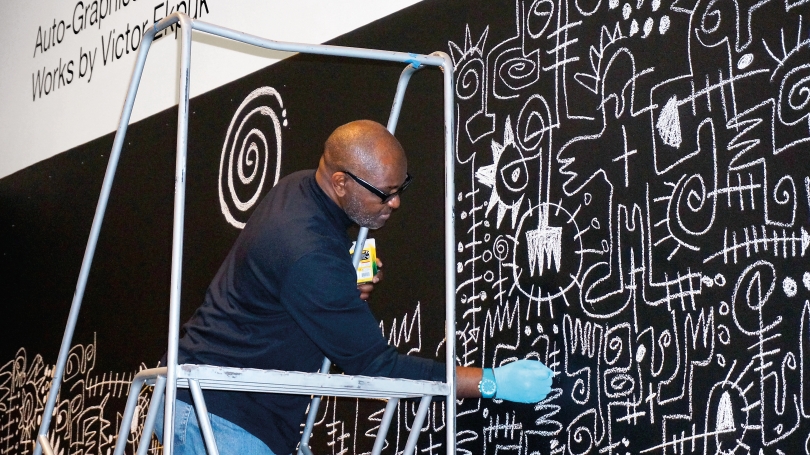 Victor Ekpuk works on a piece for Auto-Graphics