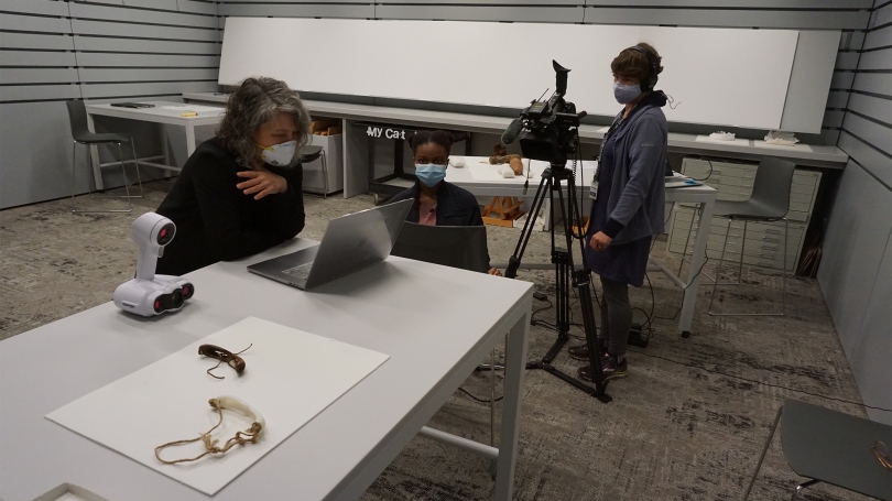 A professor talks to their students on camera in a museum smart classroom.