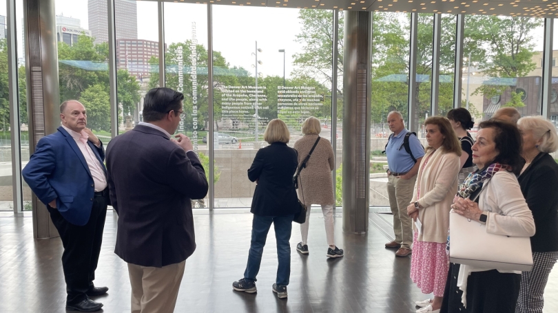 John Stomberg (left) is pictured in a Denver Art Museum atrium. He is on a tour of the Museum with the Directors Circle.