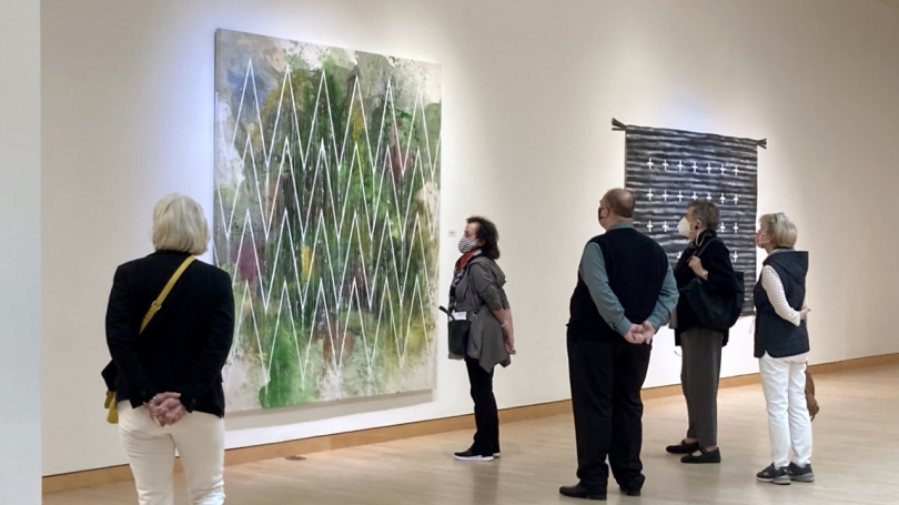 A group of adults stand in a contemporary art museum gallery.