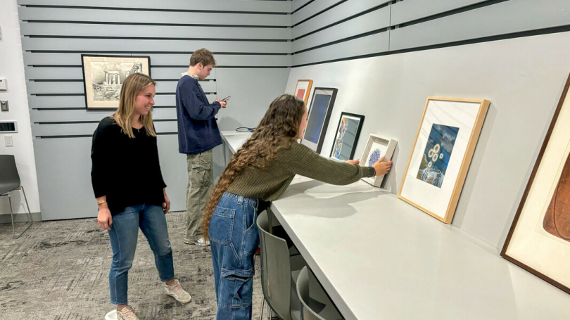 Students from Museum Club help set up art for the SALAD Program, a student art lending program for Dartmouth students. 