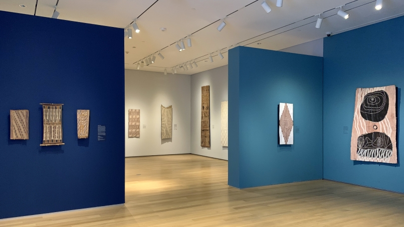 A museum gallery installed with Aboriginal Australian bark paintings.
