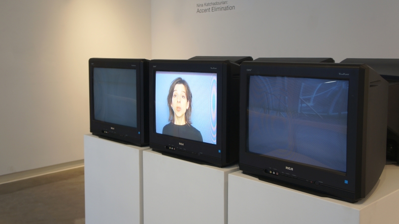 Nina Katchadourian, Accent Elimination, 2005, Six televisions, three pedestals, six-channel video (three synchronized programs and three loops), headphones and benches. Purchased through gifts from the Lathrop Fellows; 2008.36. Photo by Alison Palizzolo.