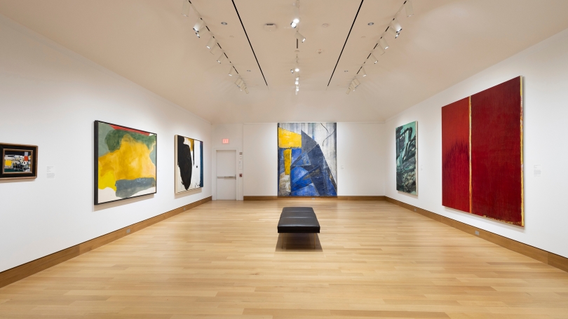 A museum gallery with white walls and six large contemporary abstract works hanging.