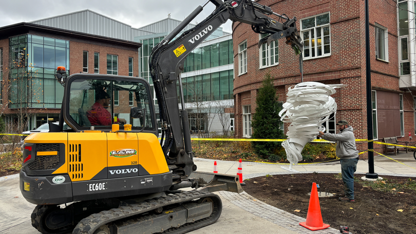 The team installs Alice Aycock's Alien Twister in its permanent location on the west side of Dartmouth's campus.  