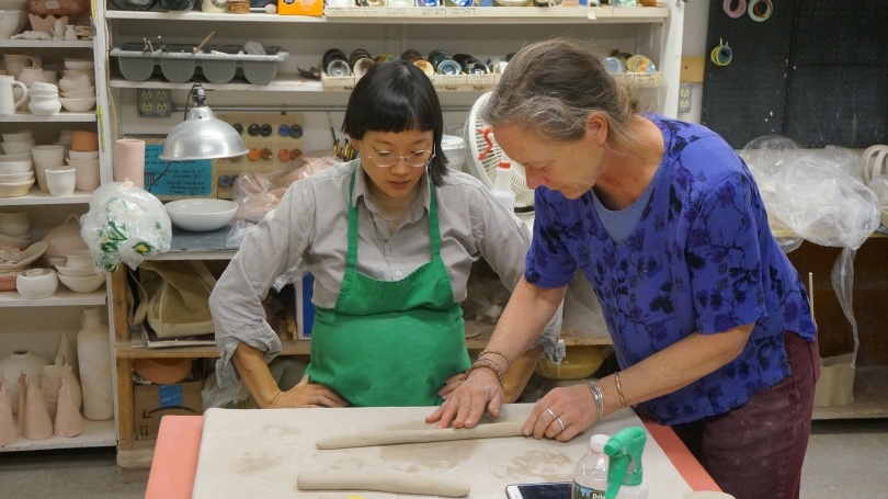 Christine Sun Kim working on components of her installation with Karin Rothwell at the Hanover League of New Hampshire Craftsmen. Photo by Amelia Kahl. 