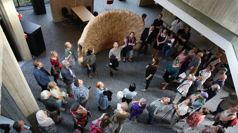 A crowd listens to Jacob Kirkegaard introduce Transmission during the Resonant Spaces symposium walking tour. View from upper floor. 