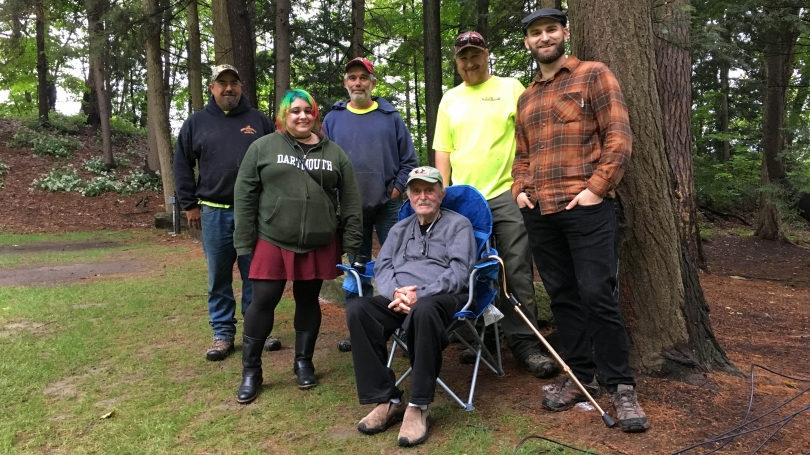 Alvin Lucier (center) poses with Dartmouth alumna Rebecca Drapkin (left), assistant Trevor Saint (right), and the three contractors who dug the holes for 5 Graves to Cairo (back row). 