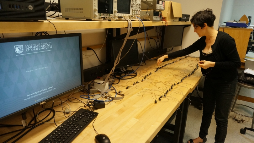 Laura Maes lays out the handmade circuits for Spikes in a Thayer School of Engineering lab.