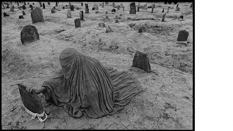 Kabul, Afghanistan, 1996. A woman dressed in a traditional burka mourns for her brother, who was killed in a Taliban rocket attack during the siege of Kabul. 