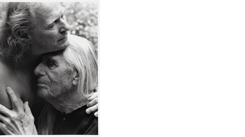 A gelatin silver print depicting two men embracing each other. 