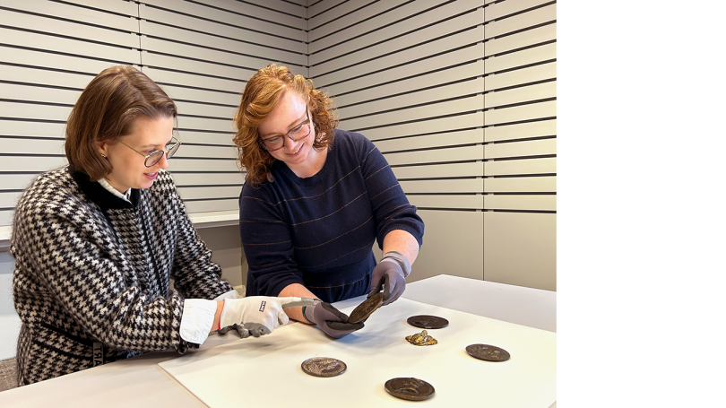 Exhibition curators Elizabeth Rice Mattison and Ashley Offill consider medals for inclusion in Living with Sculpture. 