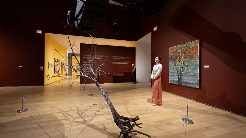 Two museum guests look and admire the instillation of "The Emissary" in "The Grief of Almost"