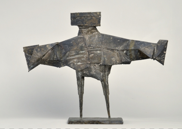 Bronze sculpture with its arms out stretched.